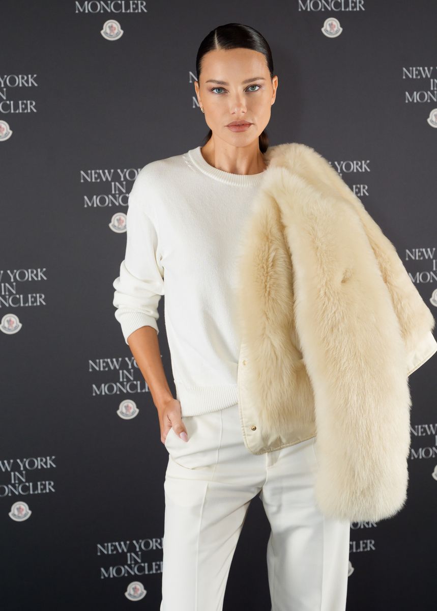Adriana Lima kicked off her fashion month appearances in New York, layering a plush cream Moncler coat over a chic tonal look.
