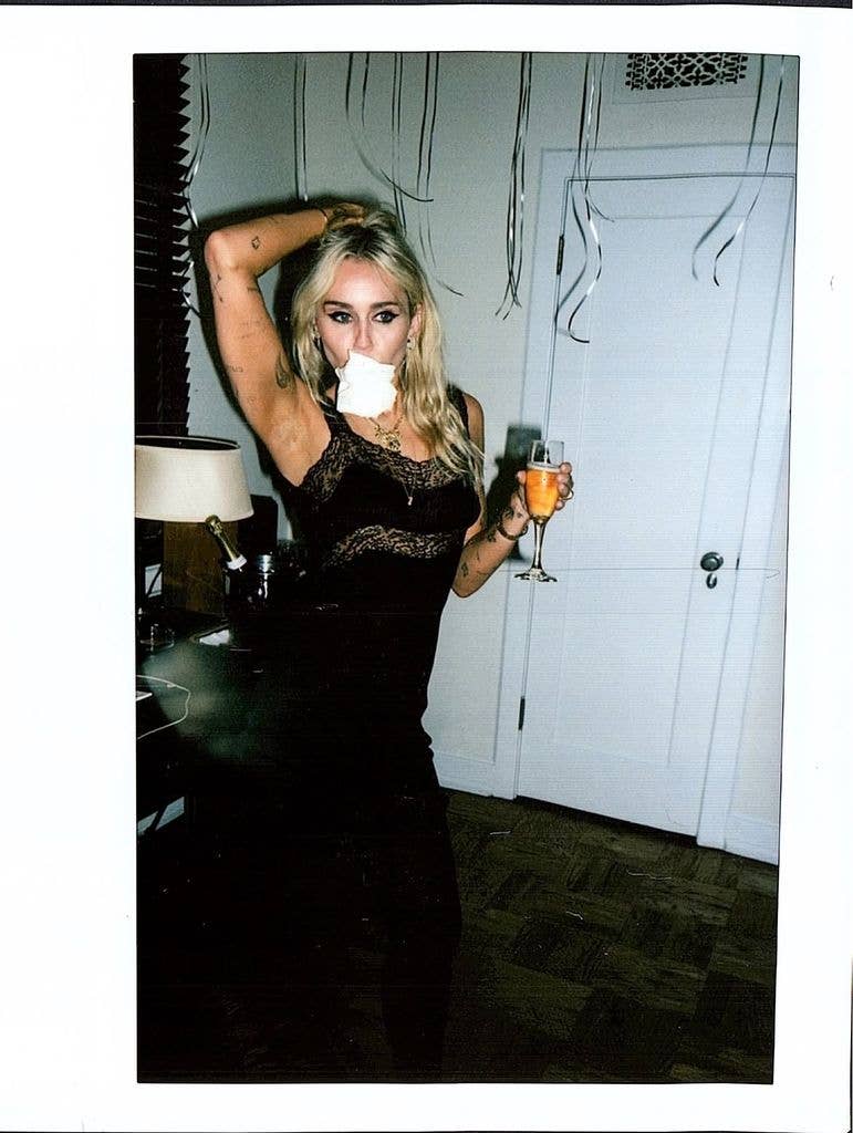 Miley's outfit combined a fitted black silhouette with sheer lace detailing, including a delicate trim around the hem