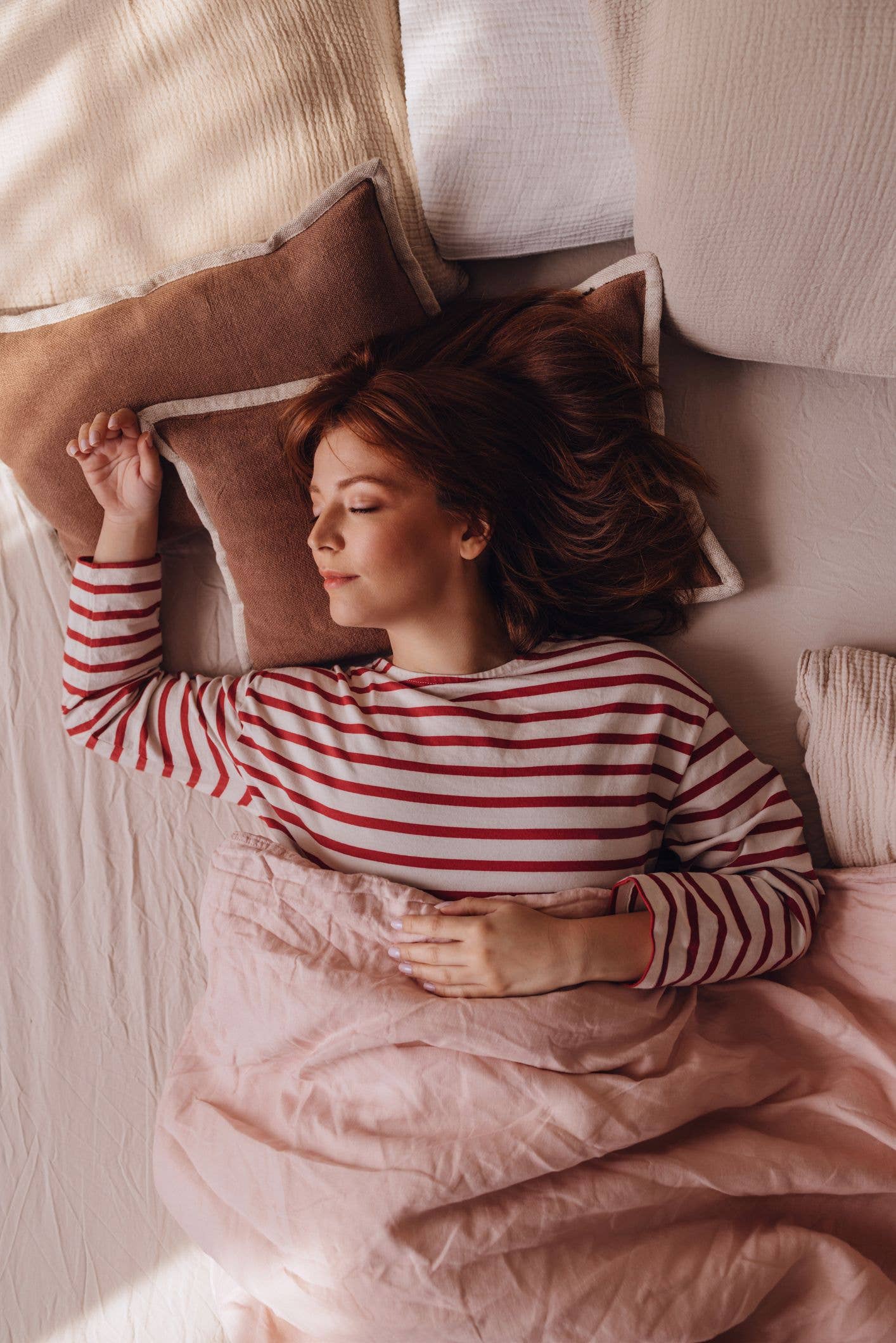 Beautiful Ginger Woman Lying in her Bed, Sleeping in on a Weekend