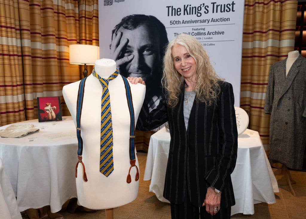 Jill Collins poses with bust displaying item '1982 Stage worn - "Phil Collins" striped tie' at The King's Trust 50thÂ anniversary auction featuring the Phil Collins archiveÂ at The Peninsula Hotel on April 21, 2026 in London, England. (Photo by Eamonn M. McCormack/Getty Images)