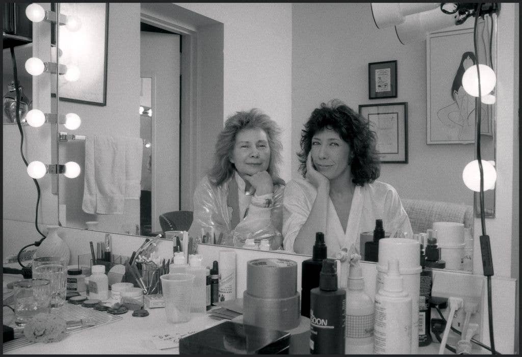 Lily Tomlin (right) an American actress, writer, comedian and Jane Wagner, American director and writer, pose in their dressing room at the Plymouth Theater, New York, NY, 1986.
