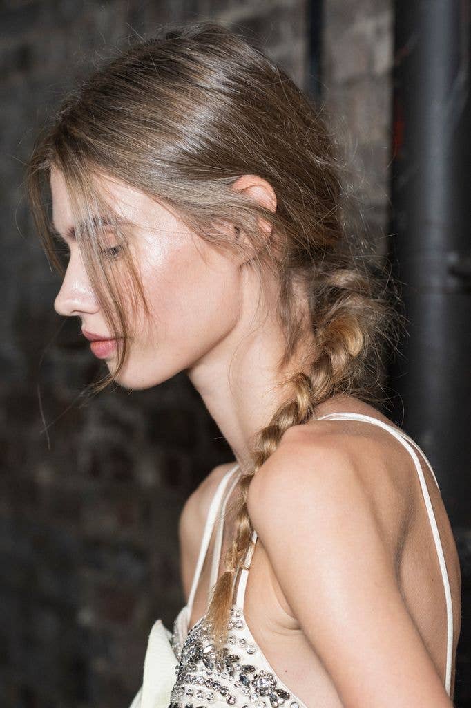 model with messy hair in plait