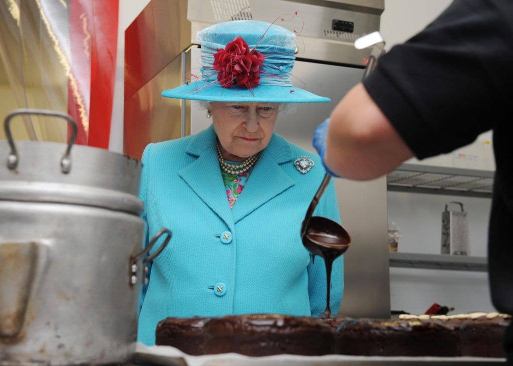 Queen Elizabeth II watching chocolate being poured