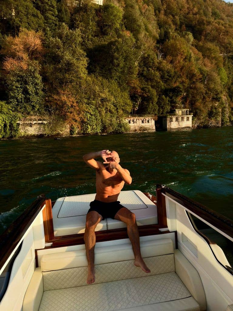 Katie Holmes' boyfriend Jason showed off his fit physique while sitting on the back of a boat shirtless
