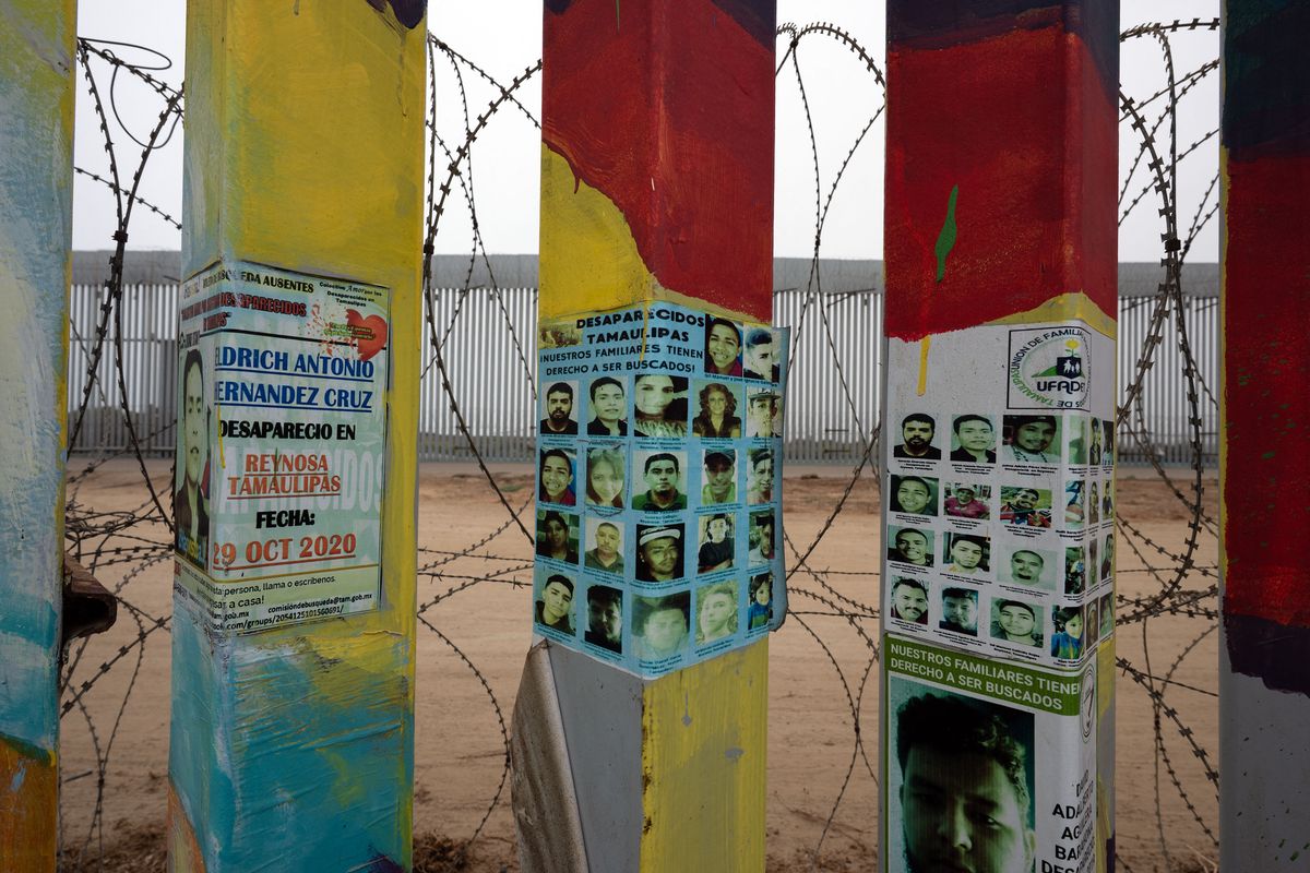 Photographs of disappeared persons are seen on the U.S.-Mexico border wall during an Amnesty International campaign honoring mothers of the disappeared and raising awareness of missing persons and the relatives searching for them