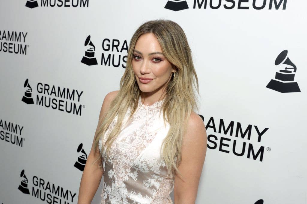 Hilary Duff wearing a white lace dress at the Grammy Museum