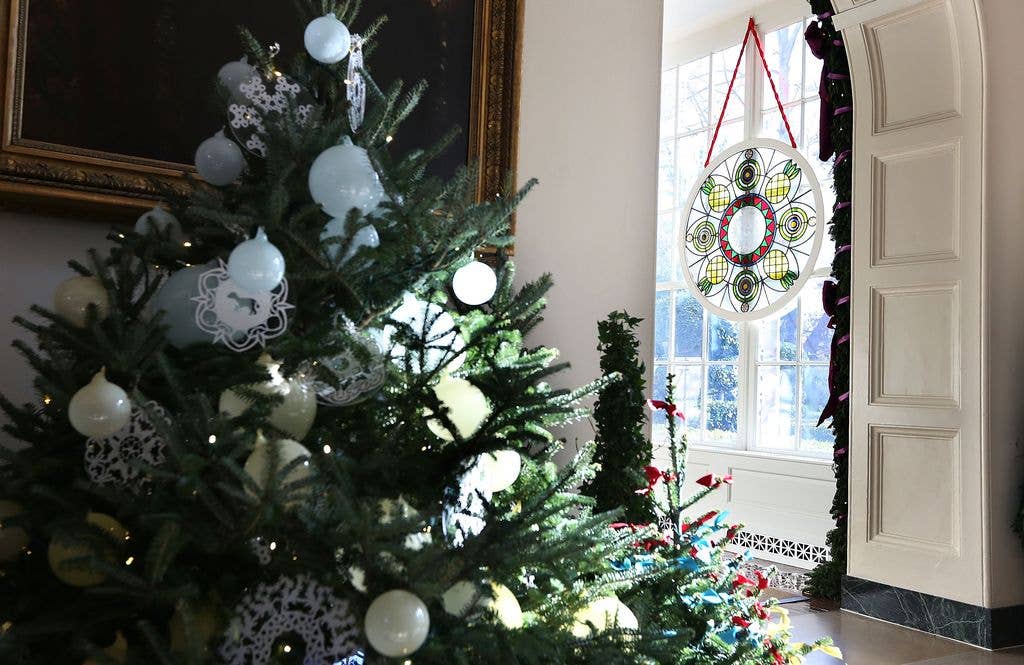 A stained glass window, created by Chicago-based artist David Lee Csicsko, is on display at the East Wing during a preview of the 2012 White House holiday decorations November 28, 2012 at the White House in Washington, DC. First lady Michelle Obama welcomed military families, including Gold Star and Blue Star parents, spouses and children, to the White House for the first viewing of the 2012 holiday decorations