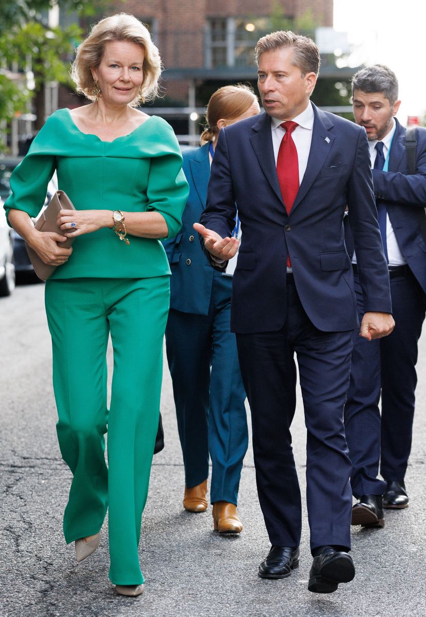 The royal’s look featured a sculptural draped neckline, fitted waist and coordinating wide-leg trousers.