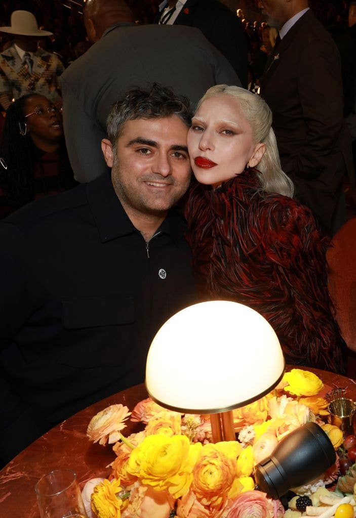 photo of lady gaga and michael polansky sitting at table grammy