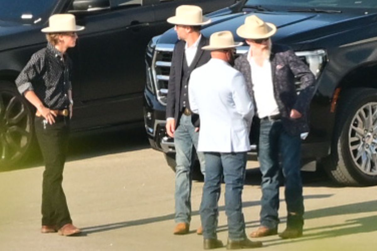 The men appeared to be wearing matching white cowboy hats