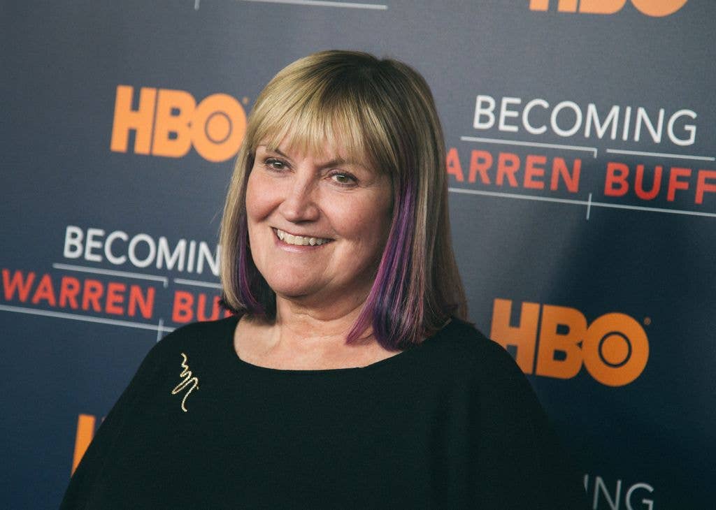 Susie Buffett smiles at the camera in front of an HBO 'Becoming Warren Buffett' step-and-repeat backdrop.
