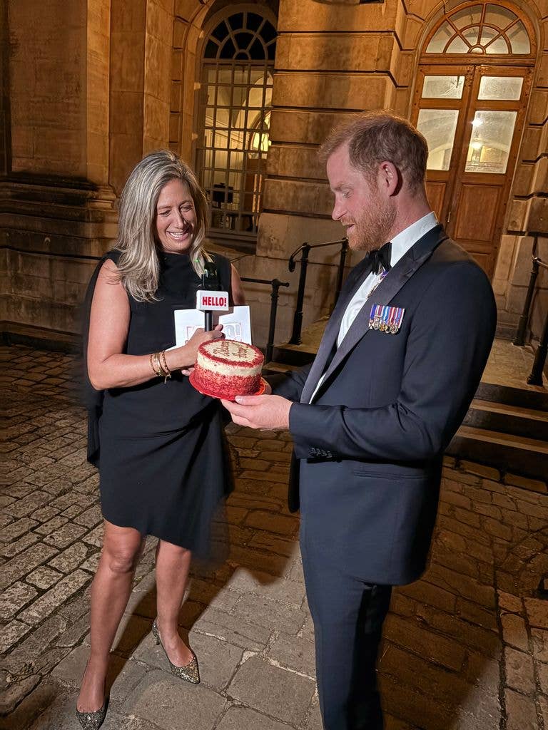 HELLO!'s Editor in Chief Jessica Callan presents Harry with a Lola's red velvet cake