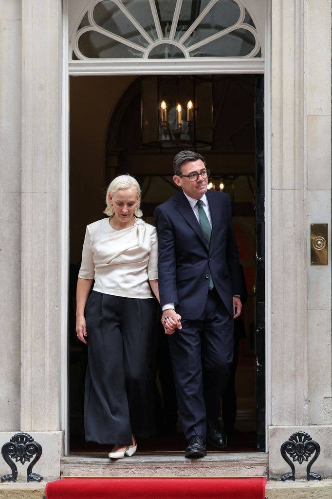 Britain's Prime Minister Andy Burnham and his wife Marie-France van Heel meet France's President Emmanuel Macron and his wife Brigitte Macron.