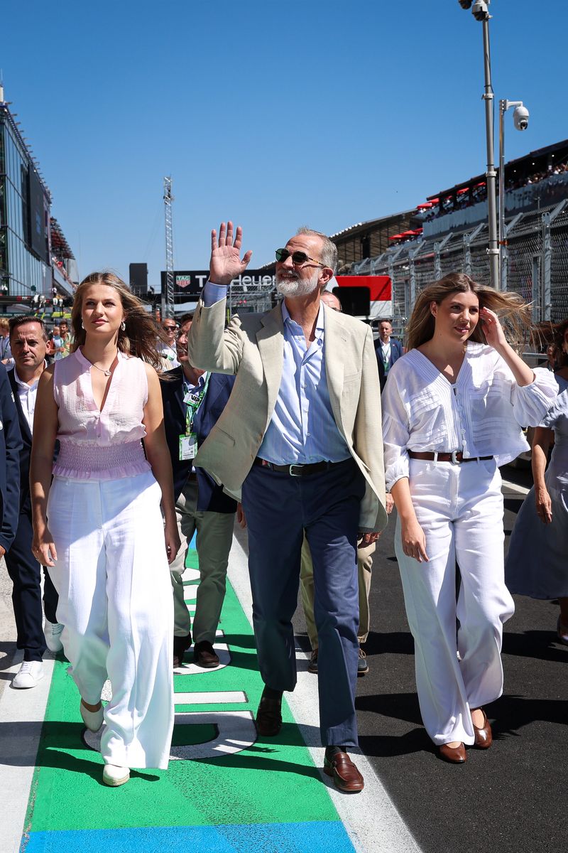 King Felipe keeps things relaxed in a beige jacket, open-collar blue shirt and navy pants as he takes in the Formula 1 action with his daughters.