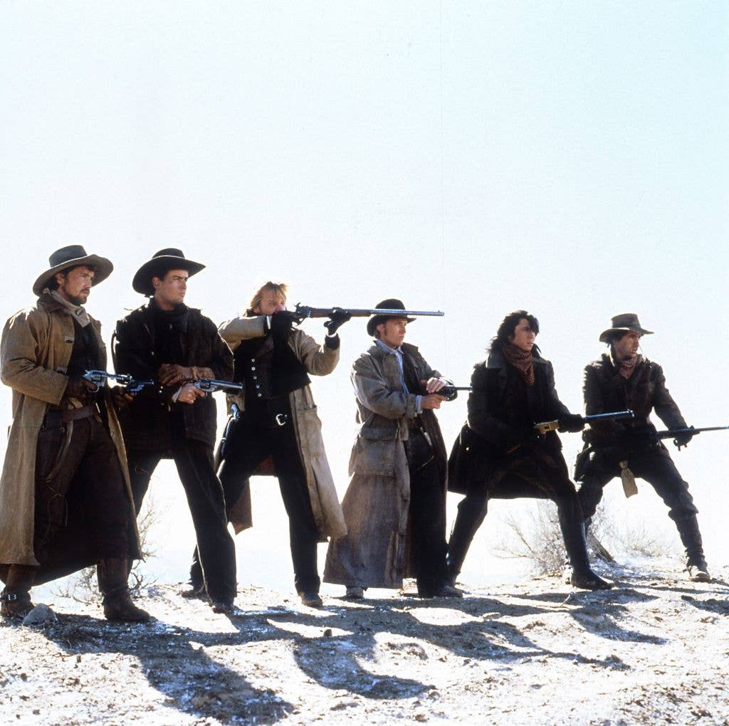 Emilio Estevez, Kiefer Sutherland,Lou Diamond Phillips, Charlie Sheen fire their guns in a scene from the film 'Young Guns', 