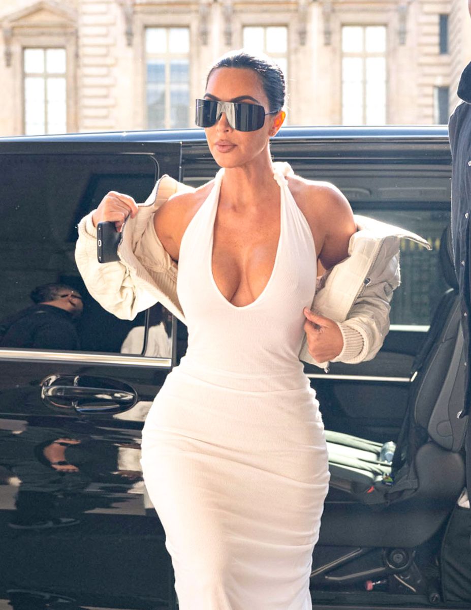 Kardashian wore the jacket slipping off her shoulders rather than fully zipped, giving the polished monochrome outfit a deliberately undone quality.
