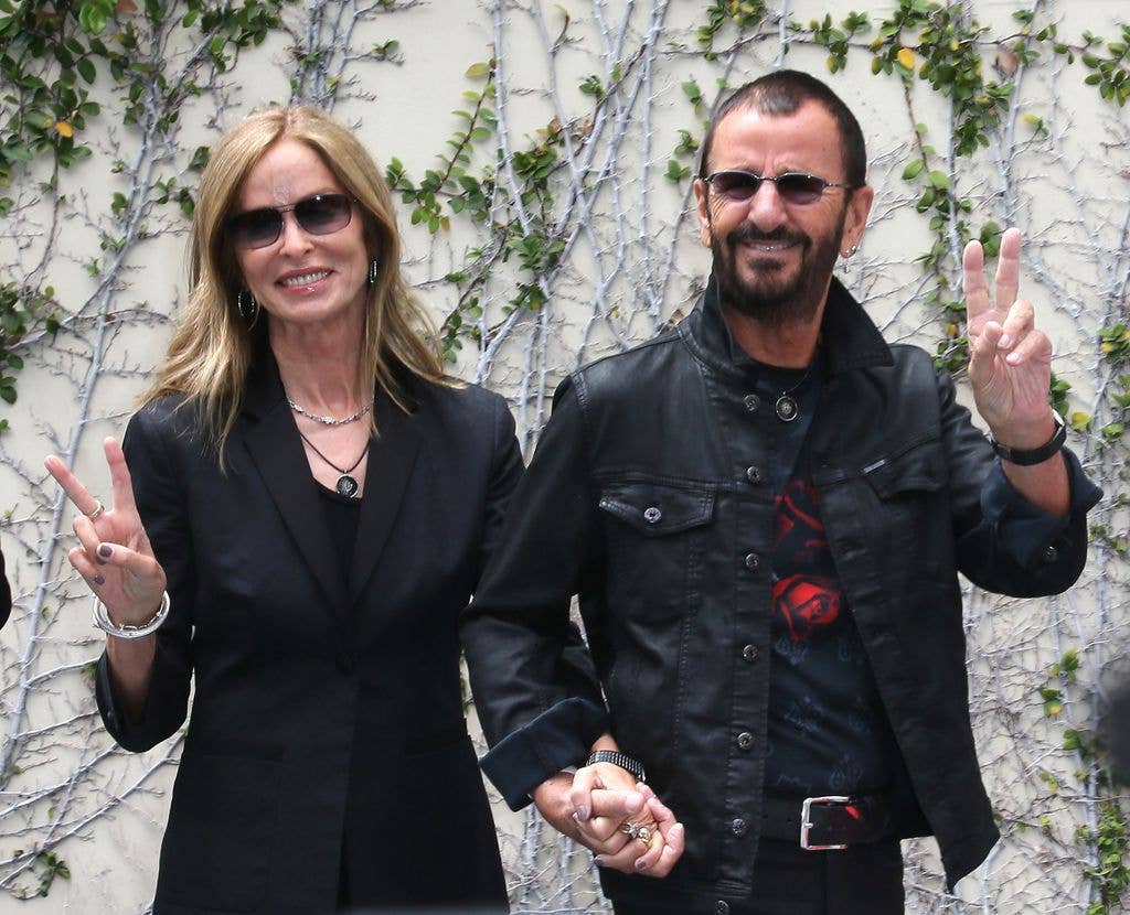 Ringo Starr holding hands with wife Barbara Bach