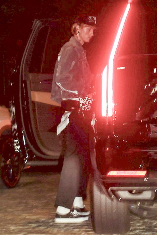 MGK was escorted inside by Dakota's security guard, wearing his outfit from the US Open