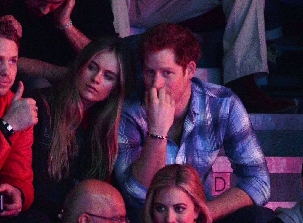 Cressida Bonas and Prince Harry sitting at an event