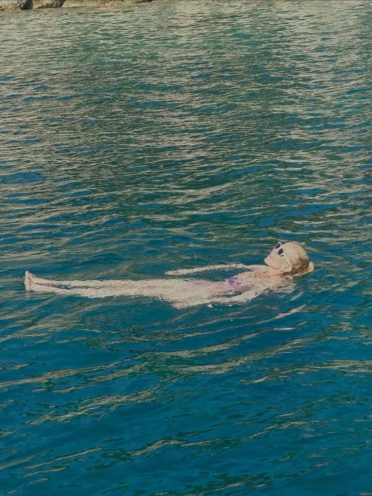 Claudia floated in crystal clear water