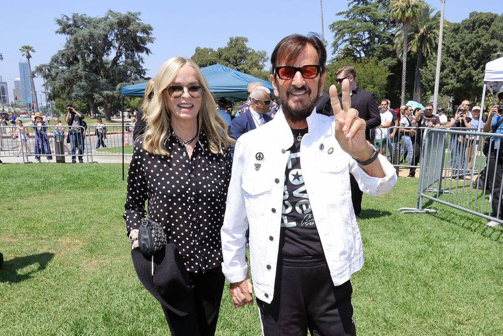 Ringo Starr holding hands with Barbara Bach