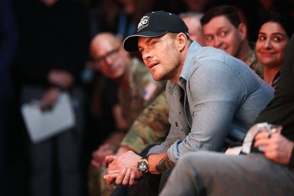 alan ritchson sitting leaning forward