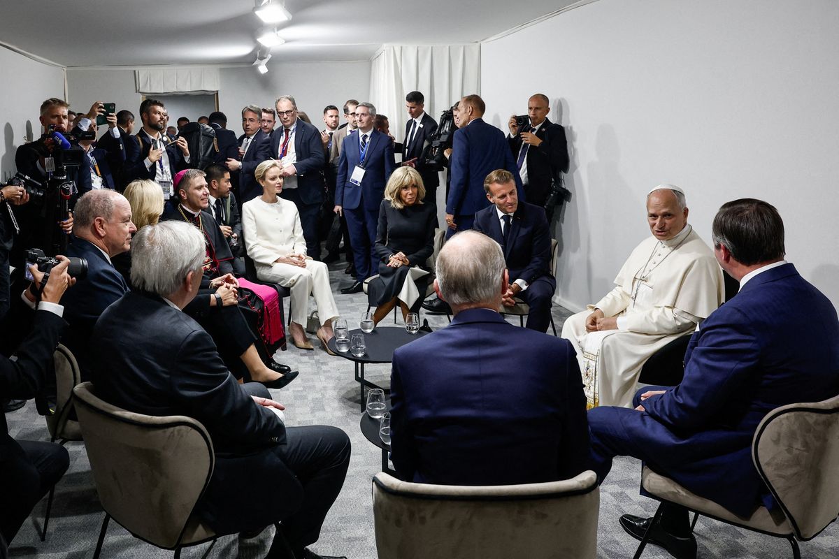 Pope Leo XIV (rear 2nd R) attends a meeting with France's President Emmanuel Macron (C) and his wife Brigitte Macron (5th L), Princess Charlene of Monaco (4th L), Prince Albert II of Monaco (L)
