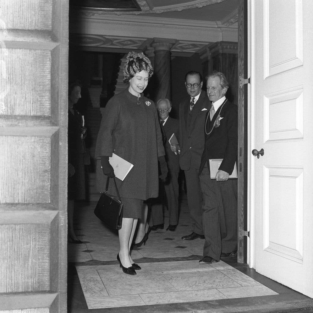 The Queen who expects her fourth child in the New Year, looks radiantly happy as she leaves Burlington House, Piccadilly, London
