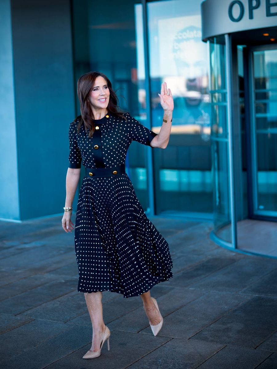 Queen Mary of Denmark stepped out in Copenhagen wearing a timeless black-and-white polka-dot dress with eye-catching gold details.