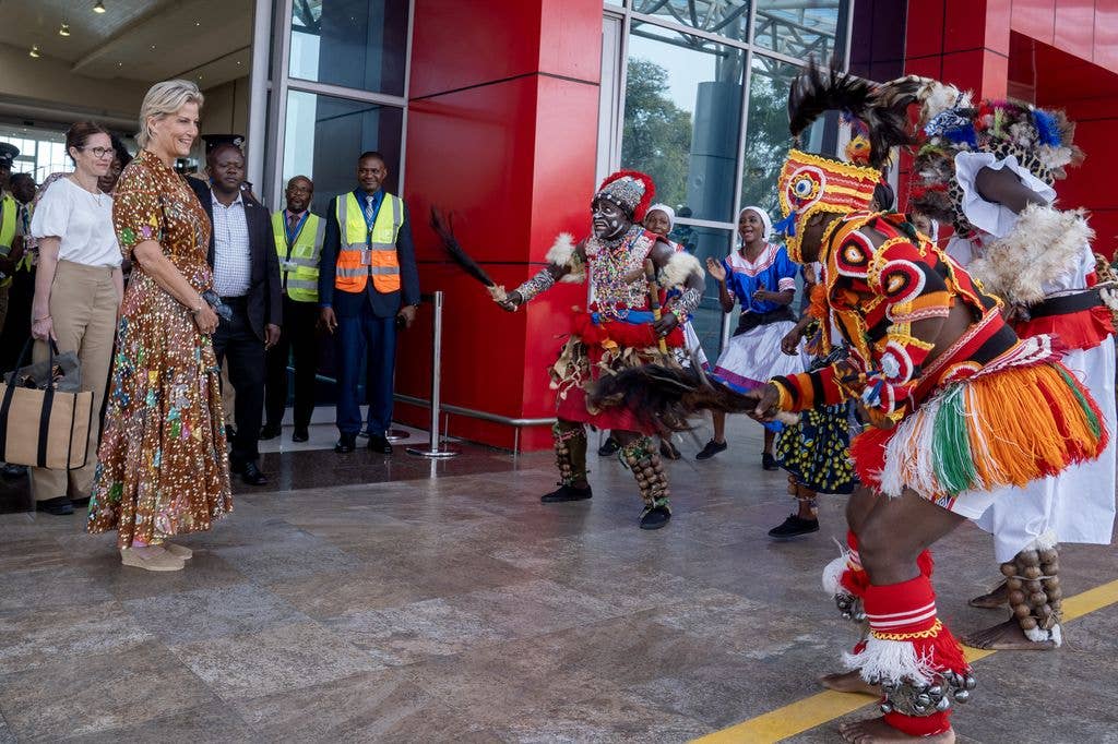 The Duchess of Edinburgh is greeted by traditional Zambian dancers at Harry Mwanga Nkumbula International Airport