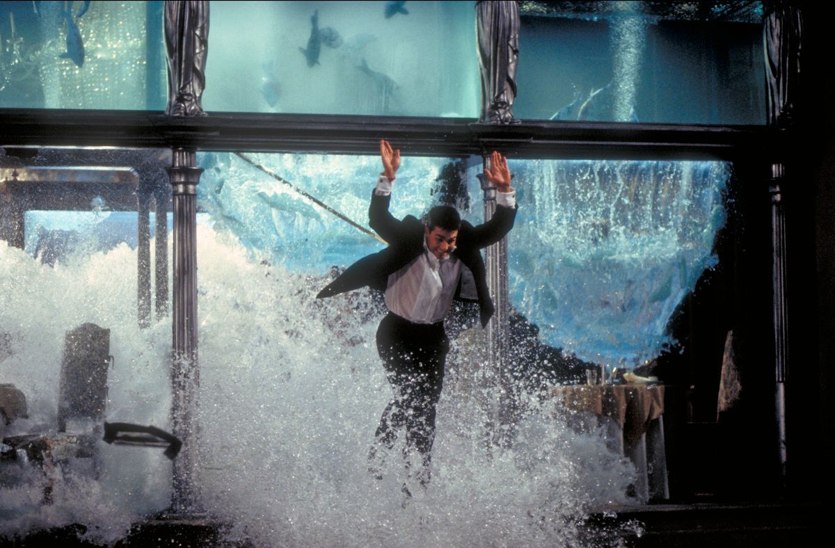 Tom Cruise as Ethan Hunt, escaping through the collapsing aquarium in a restaurant, in a scene from the film 'Mission: Impossible', 1996