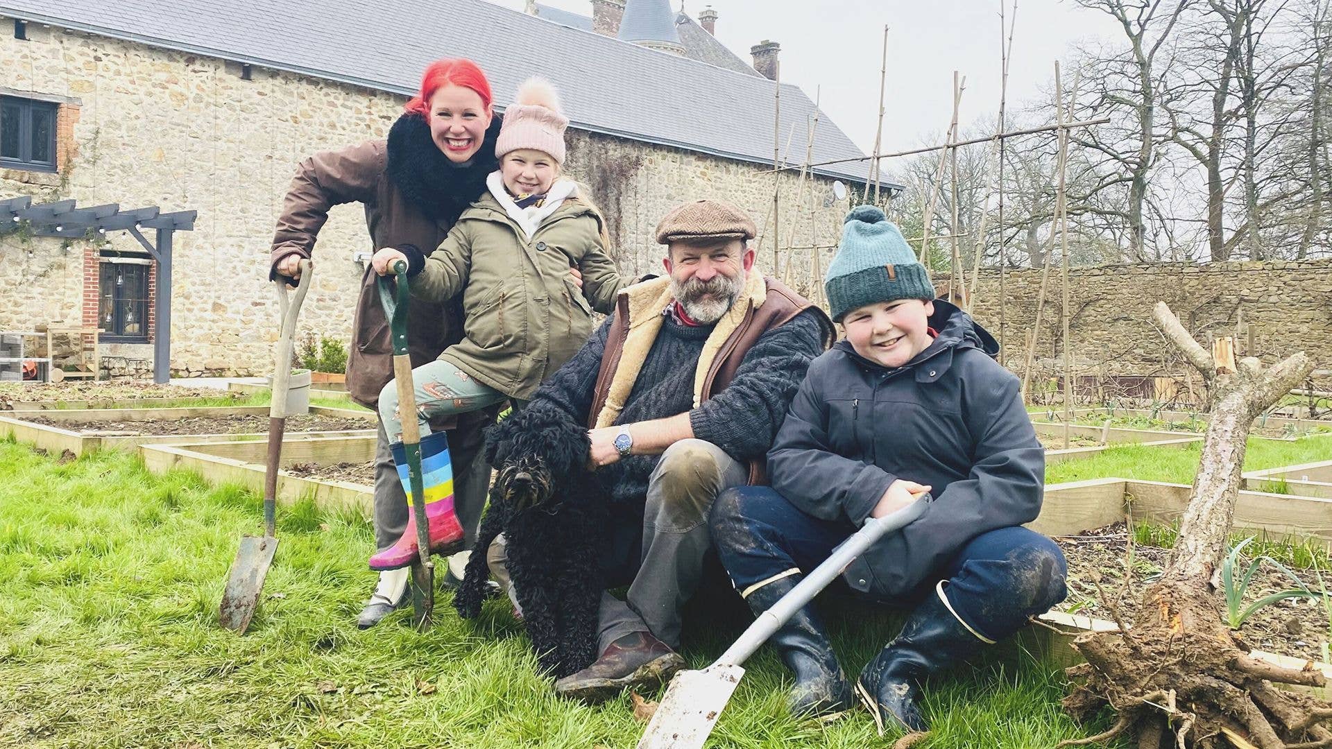 Angel and Dick digging in the garden with their children Arthur and Dorothy