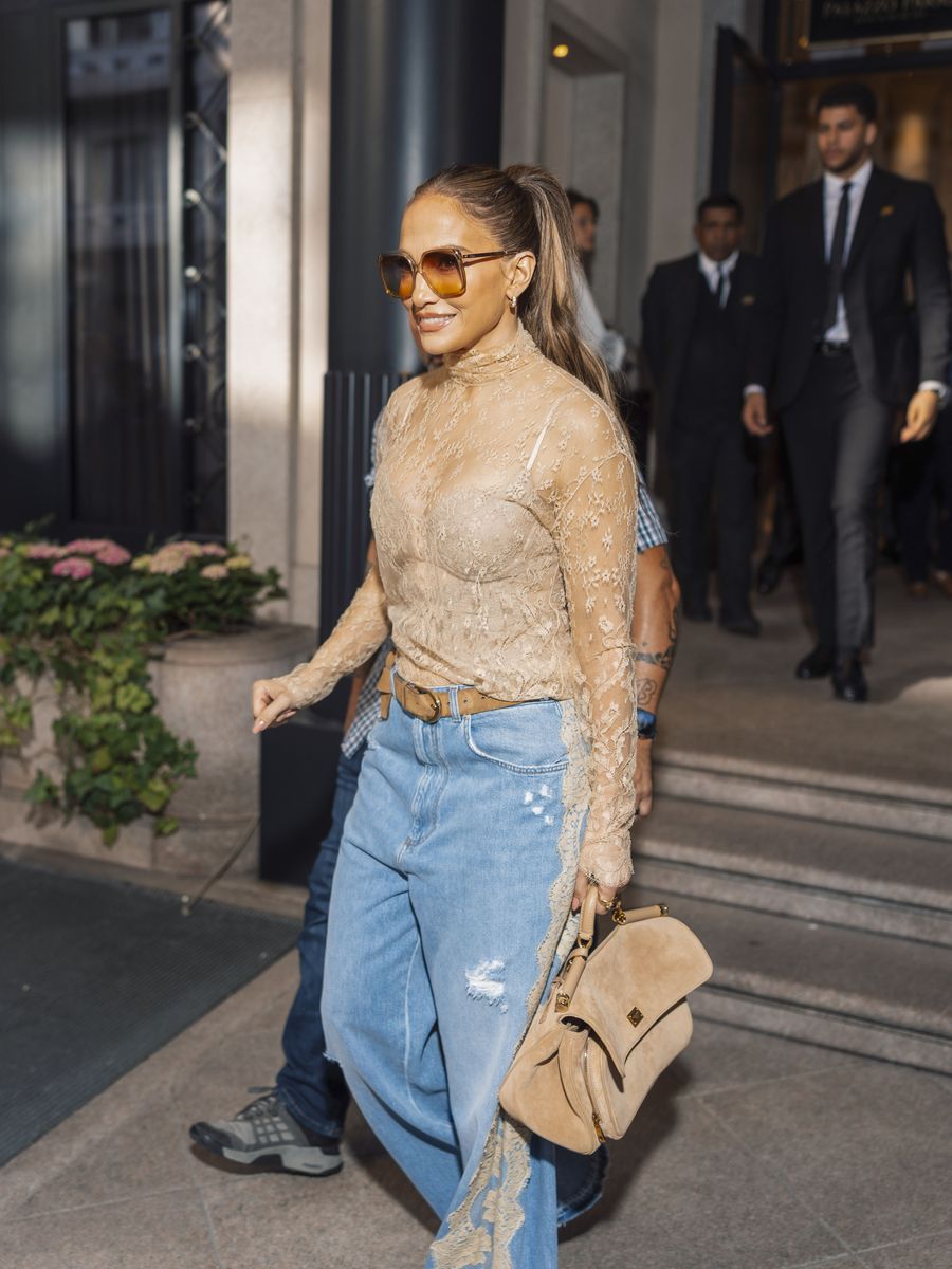 Jennifer Lopez stepped out during Milan Fashion Week in a romantic lace-and-denim look.