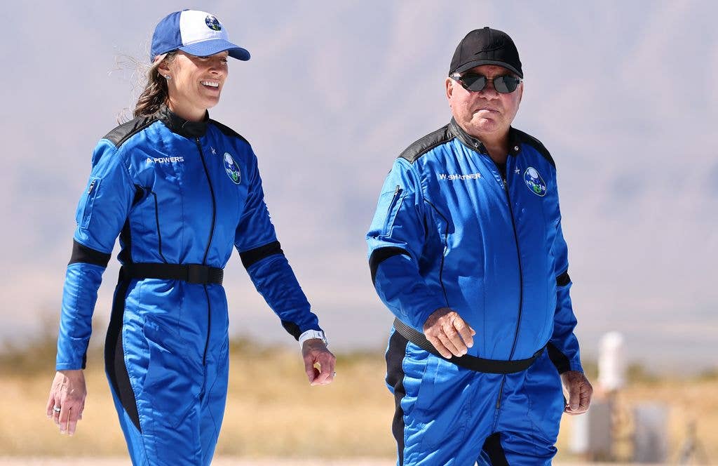 Blue Origin vice president of mission and flight operations Audrey Powers (L) walks with Star Trek actor William Shatner to a media availability on the landing pad of Blue Origin