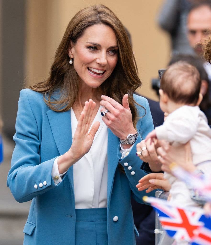 Kate Middleton looking at a young baby