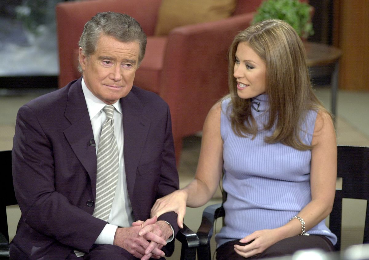 Talk show host Regis Philbin and new co-host Kelly Ripa speak to the audience during a broadcast of "Live with Regis and Kelly."