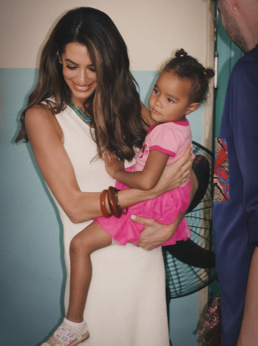 Amal Clooney shared a sweet moment with a young girl during her humanitarian trip to Malawi.