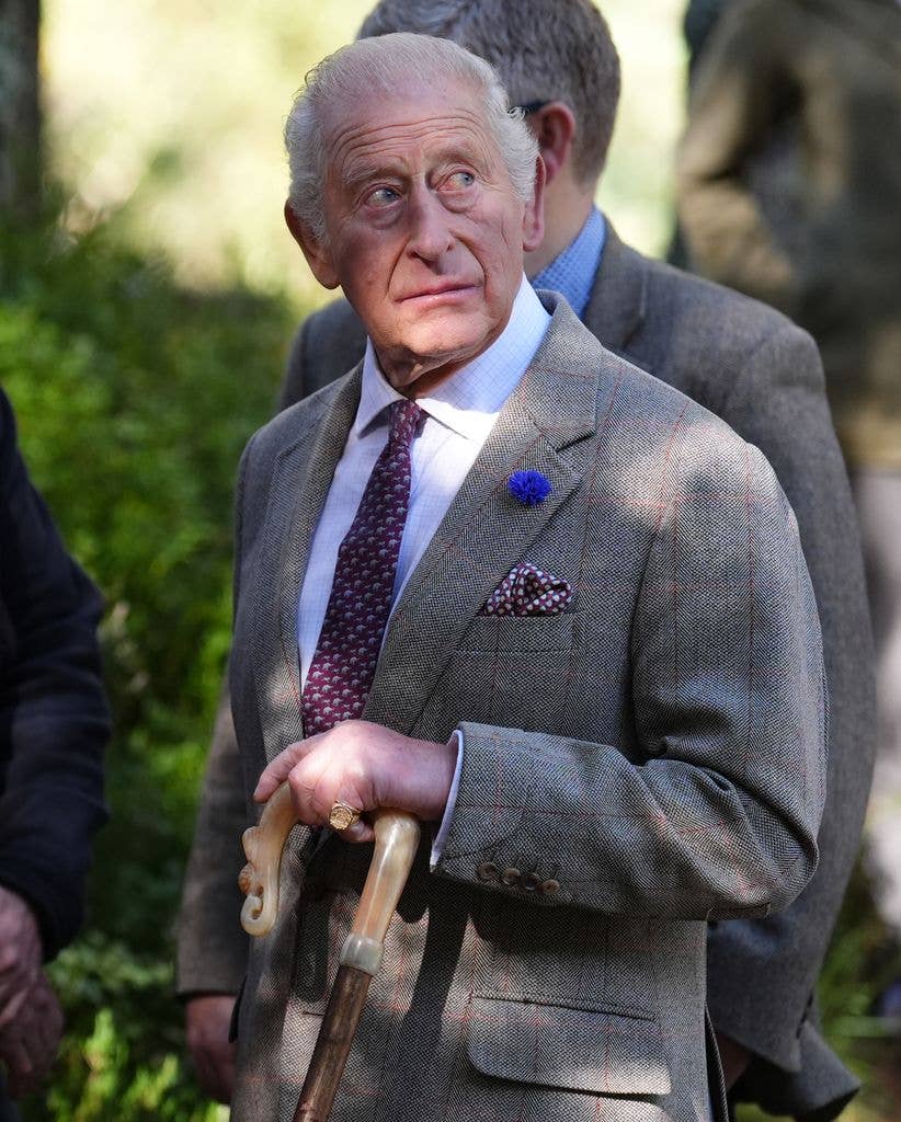 King Charles using a walking stick in the highlands