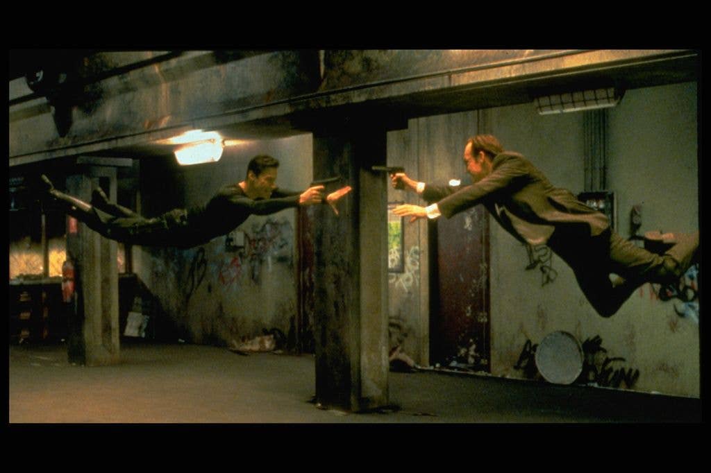 Keanu Reeves and Hugo Weaving face each other in a scene from Andy and Larry Wachowski's 1999 movie The Matrix.